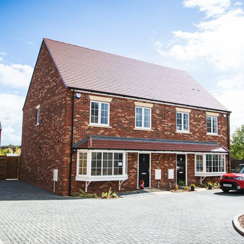 brown brick house under blue sky during daytime